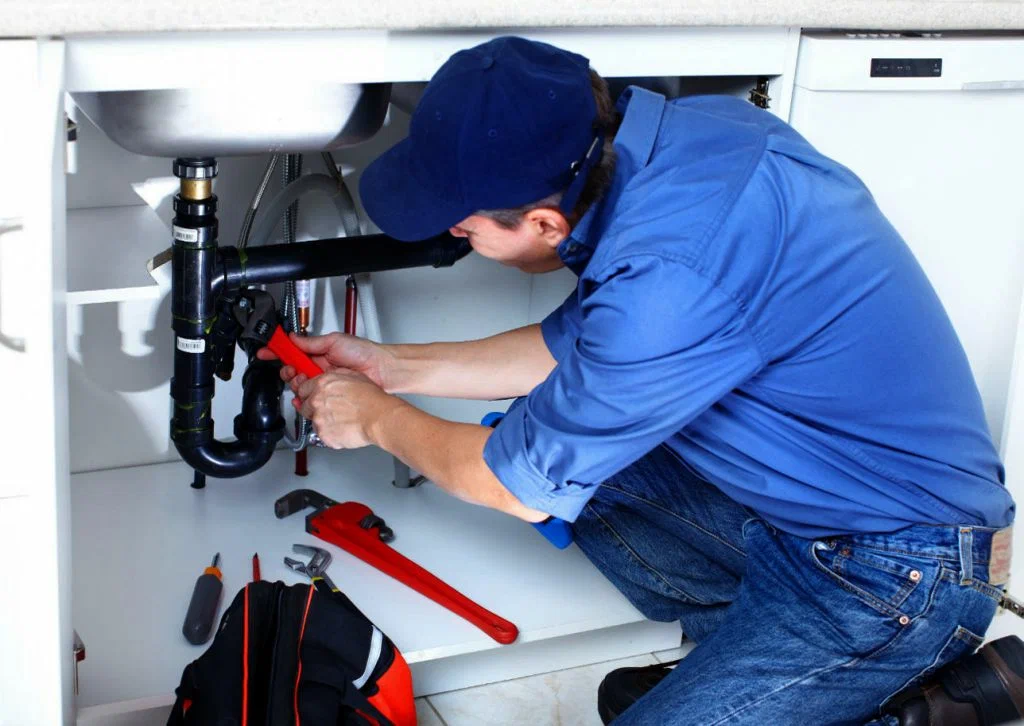Paso Plumbing licensed technician repairing bathroom sink pipes in El Paso TX home