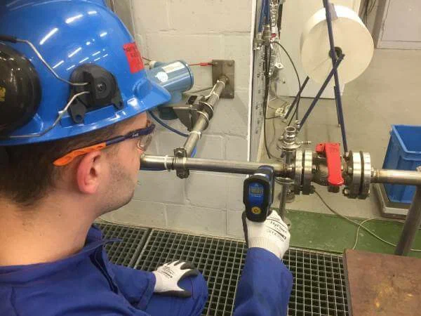 Wall leak detection technician using thermal imaging in El Paso, TX home